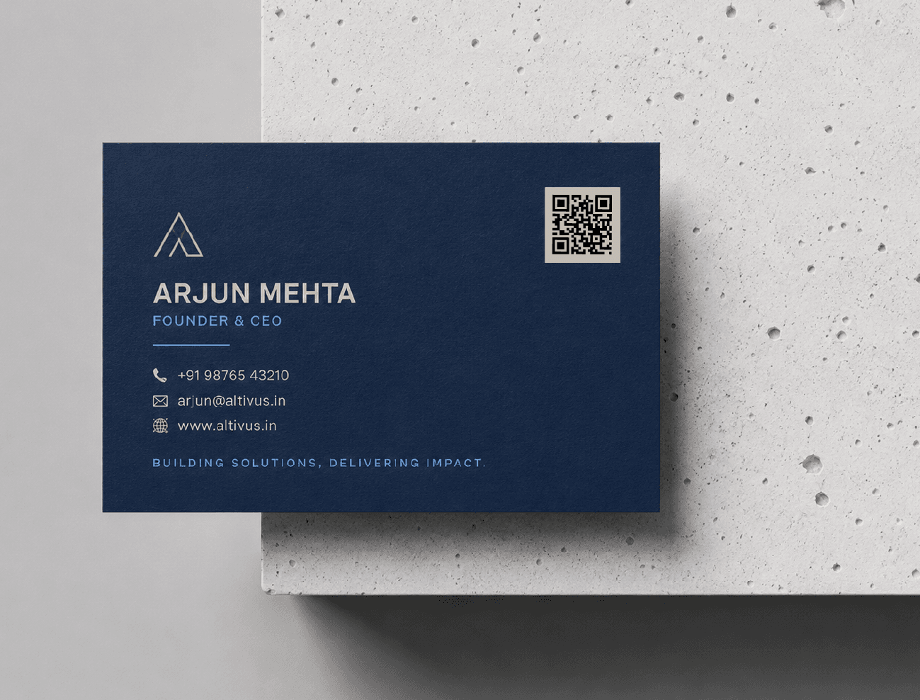 A navy business card with a QR code in the top corner